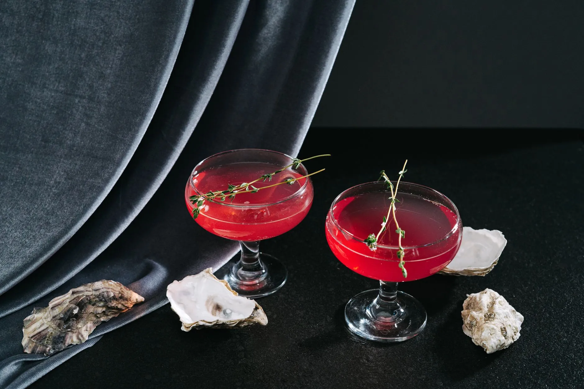 Zwei elegante Cocktails mit Kräuter-Garnitur
